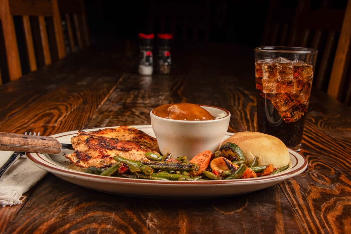Blackened Cajun chicken with green beans, dinner roll, and mashed potatoes at Blackwell Revival in Atkins, Arkansas