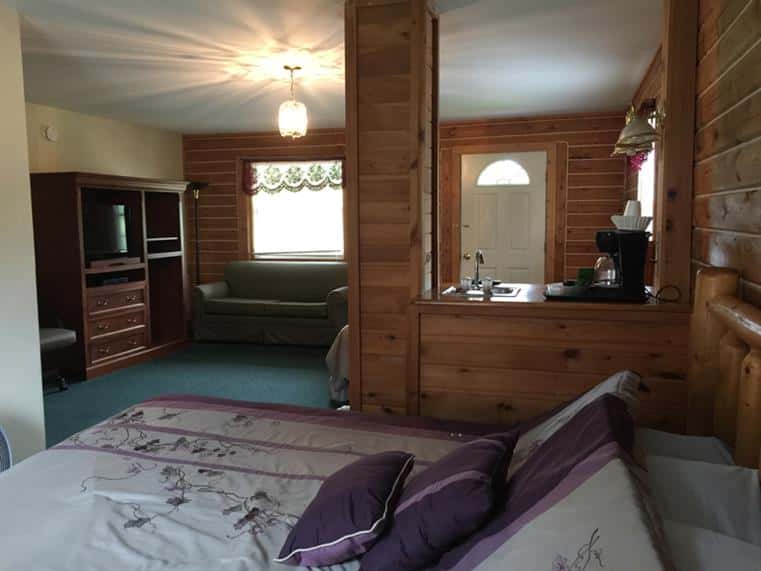 Single story motel interior with beds near windows