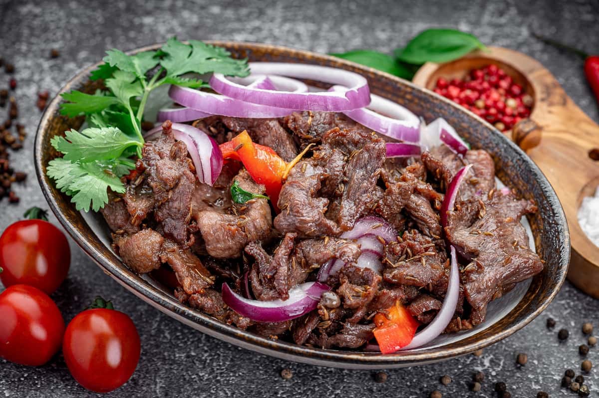 Grilled kebab platter with onions and peppers at Laghman Express