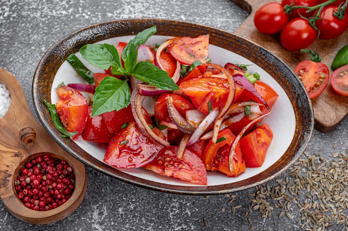 Fresh tomato and red onion salad with herbs at Laghman Express