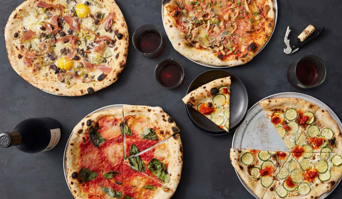 variety of italian pizzas with wine