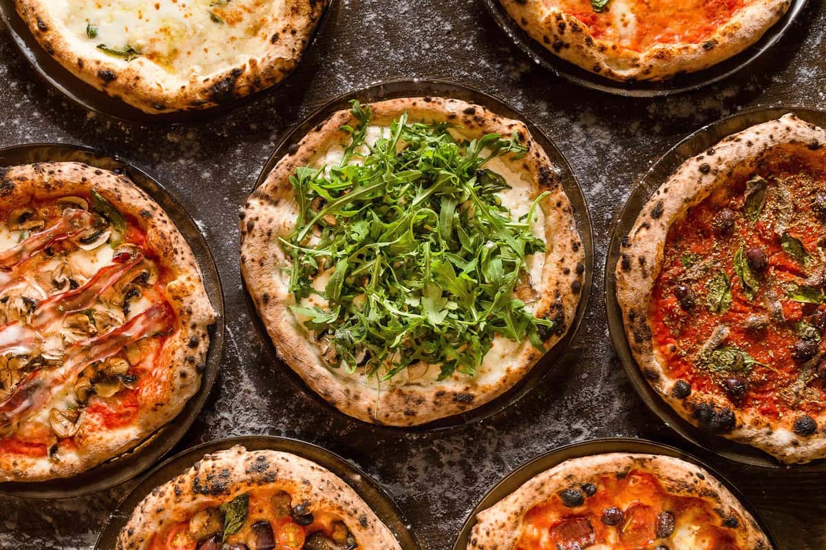 A variety of pizzas on a table