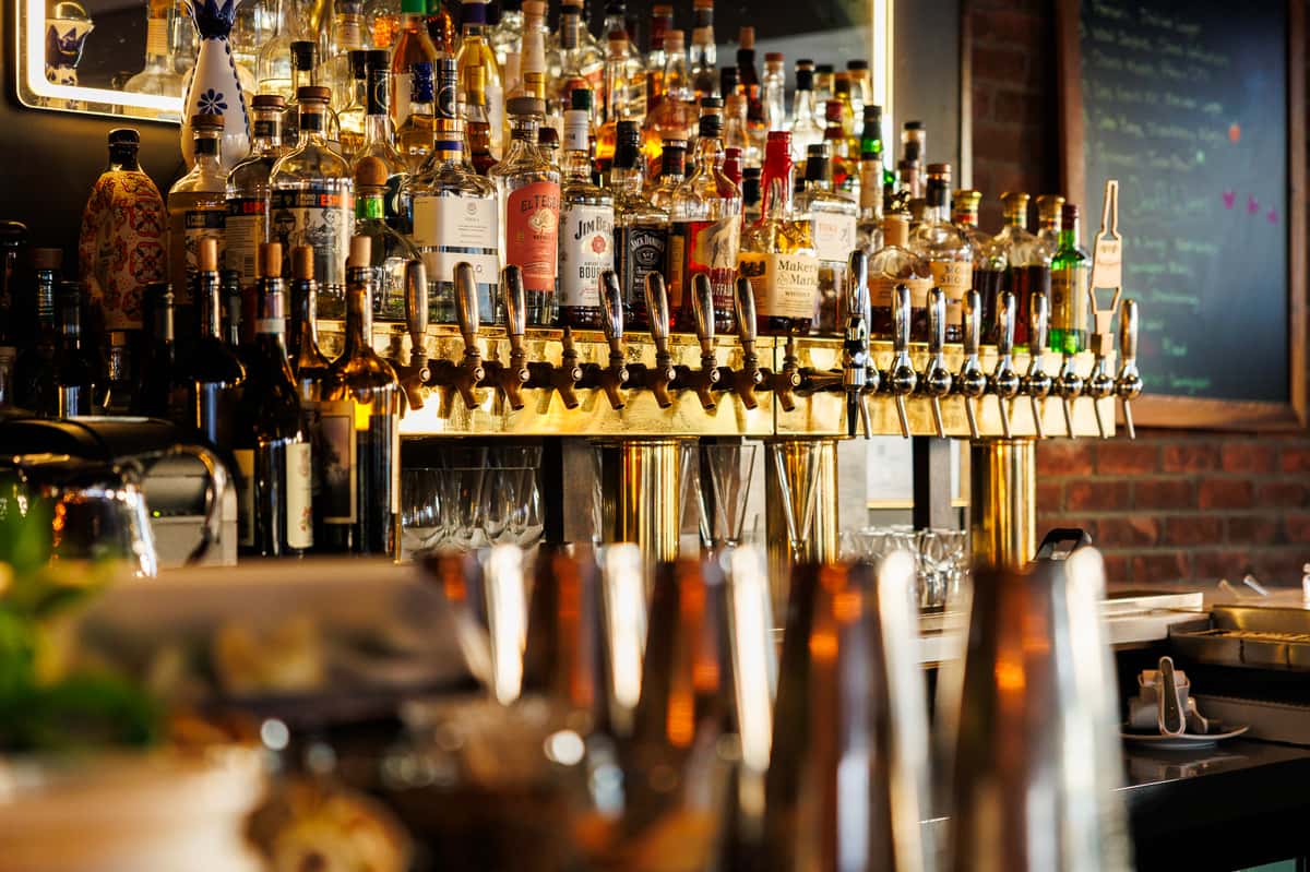 Extensive back bar display featuring premium spirits, craft cocktail ingredients, and polished barware at EVO Old Town Scottsdale.