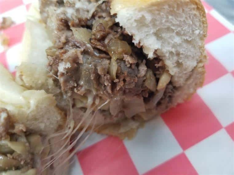 Philly cheesesteak sandwich cut in half