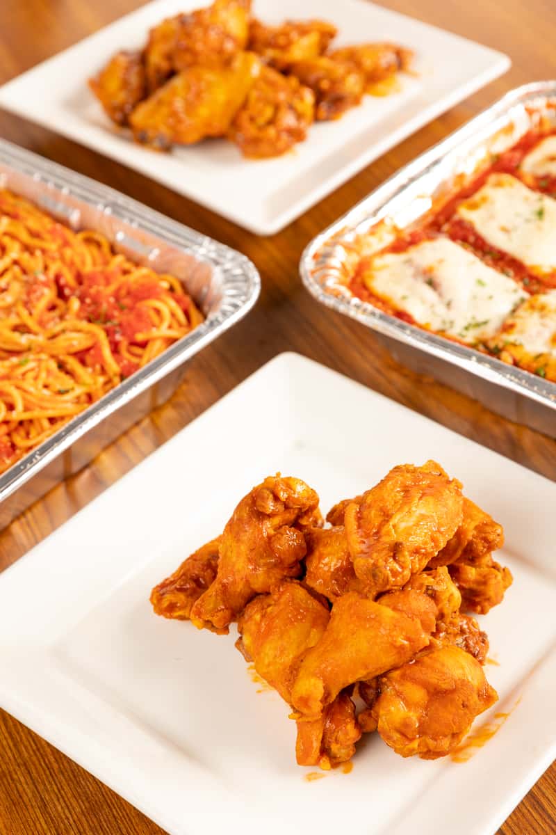 catering trays with wings, lasagne, spaghetti