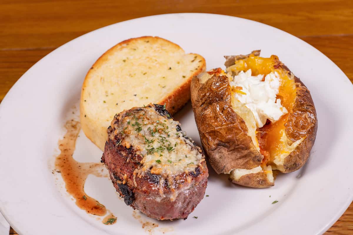 Spicy Cajun sirloin filet with baked potato at Jake & Rip's steakhouse in Grenada, Mississippi.