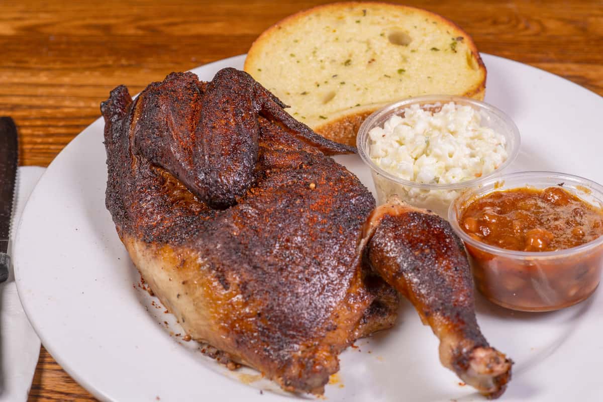 Barbecue smoked half chicken plate with sides at Jake & Rip's in Grenada, Mississippi.