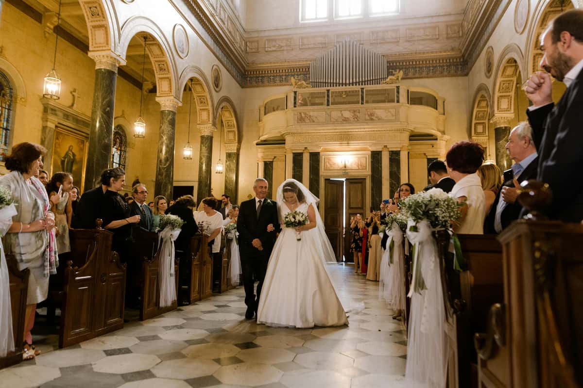 groom and bride walking down the isle
