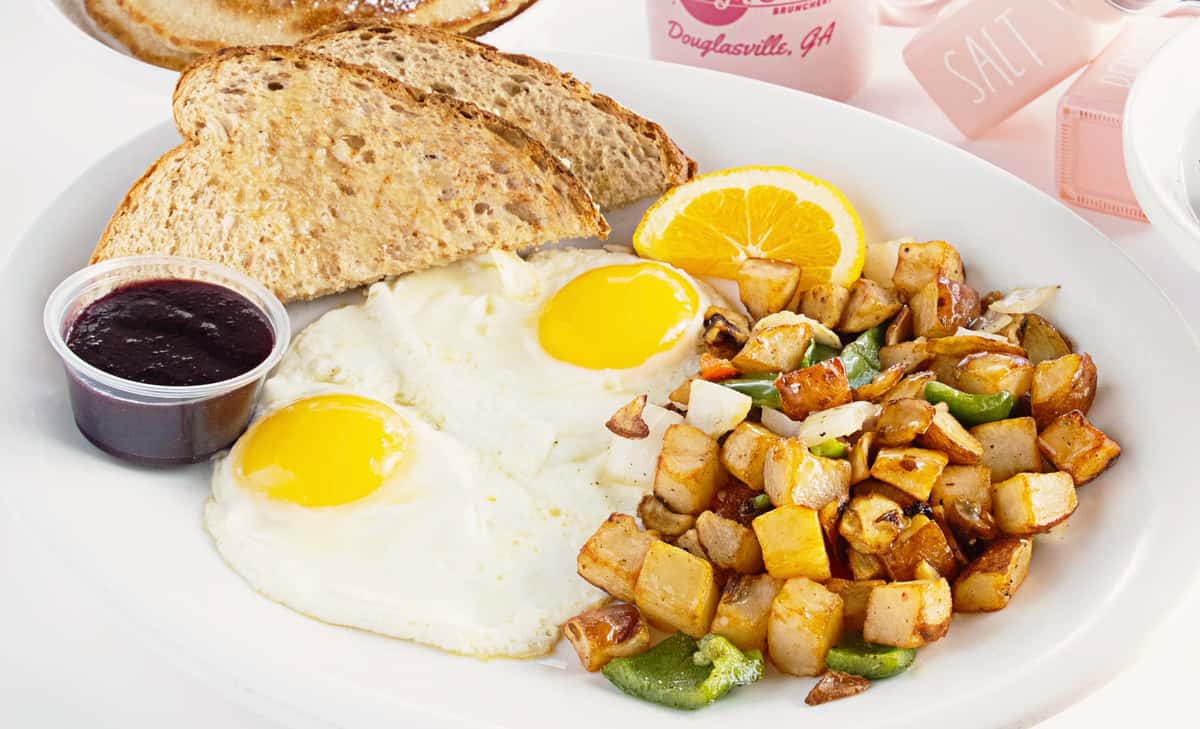eggs and toast with fruit slice and salad
