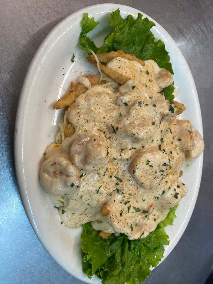 cooked scallops over a bed of rice in a bowl 