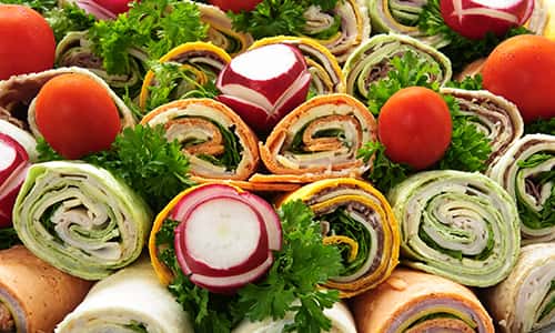 Assorted vegetable wraps in pile