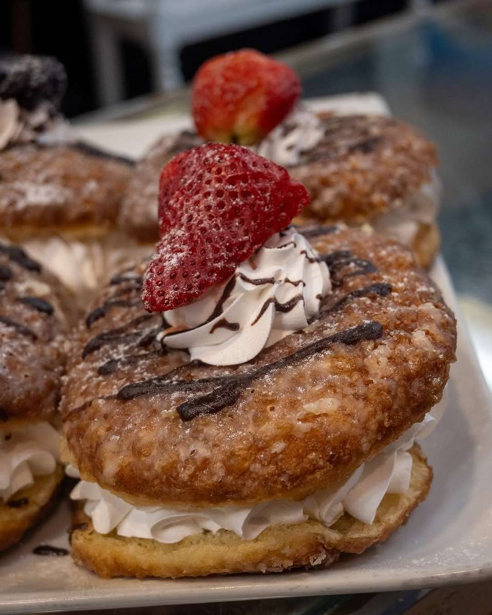 A donut with icing and a strawberry on it