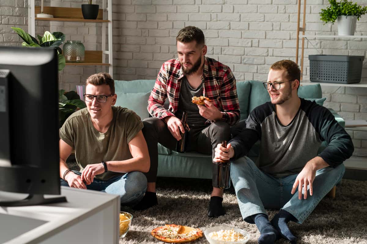 guys with pizza at home
