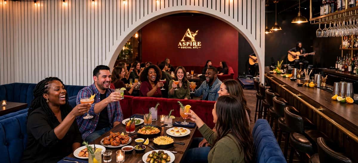 Celebration seen through a white arched wall opening, with red booths beyond, a bar on the right, and a gold Aspire logo on a dark red wall