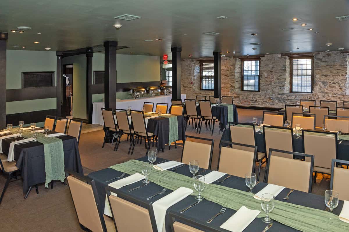 banquet-style dining room with formal table arrangements and spacious seating layout