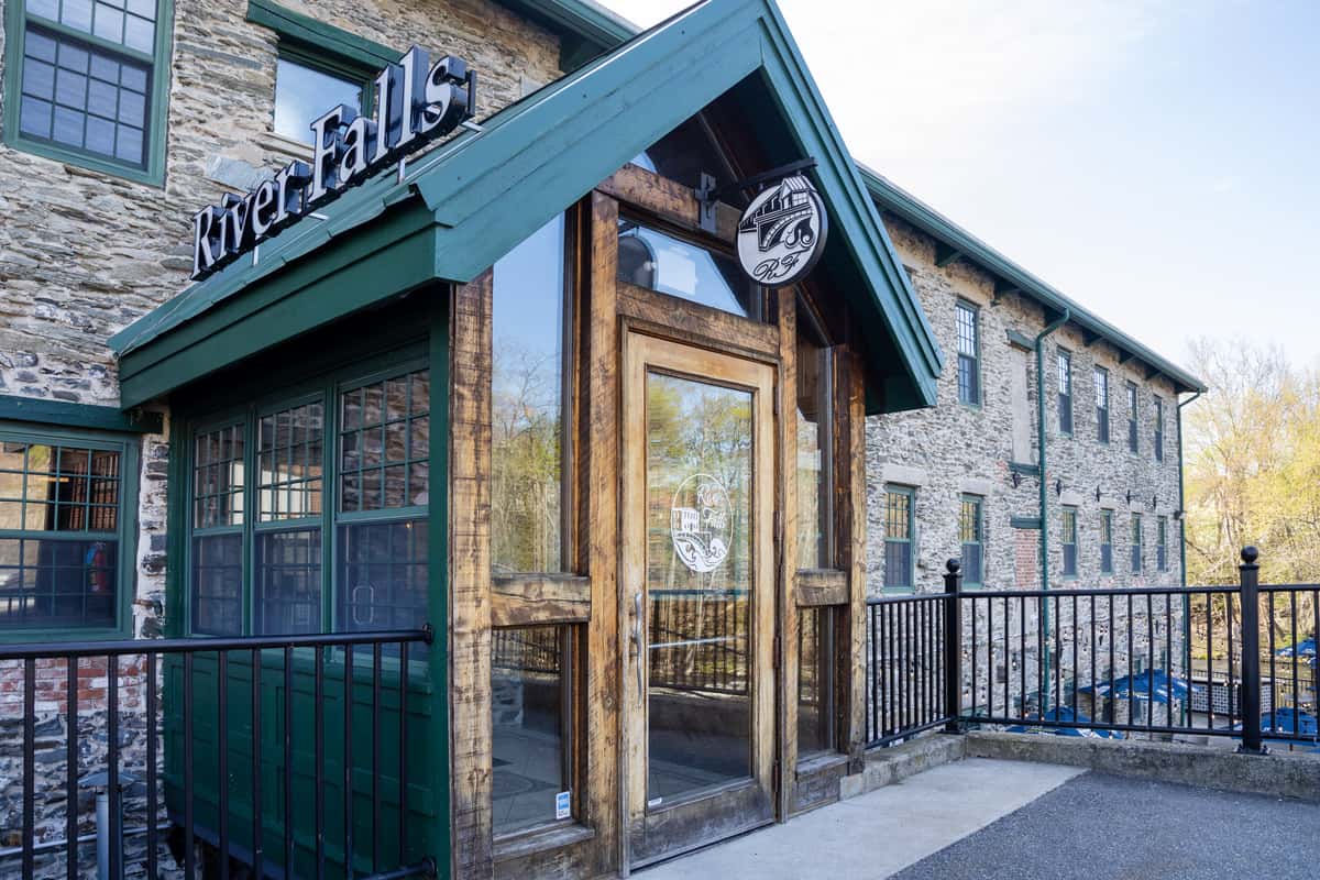 rustic stone restaurant exterior with covered entrance and outdoor architectural details