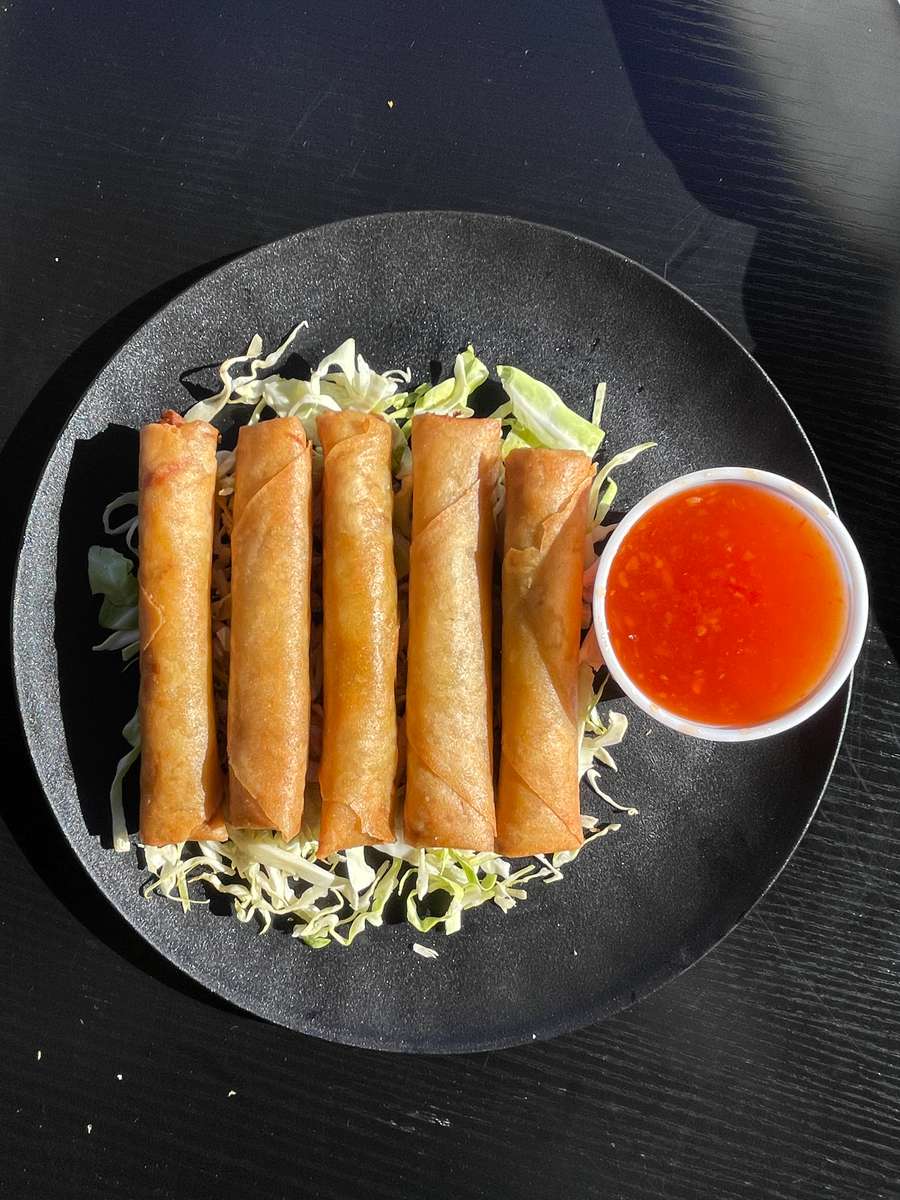Handmade eggrolls with beef, carrot, and glass noodles, served with sweet chili sauce