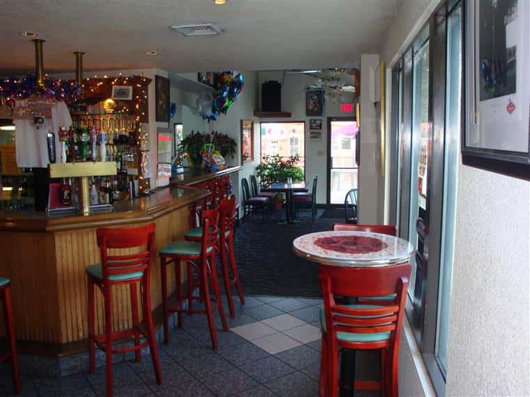 interior bar area with stools and decorative lighting
