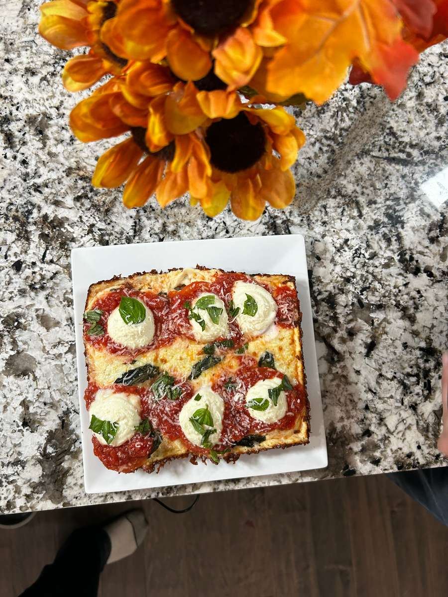 Red Stripe pizza, Fresh mozzarella blend, basil, vine-ripened peeled tomato sauce, oregano and parmesan cheese.