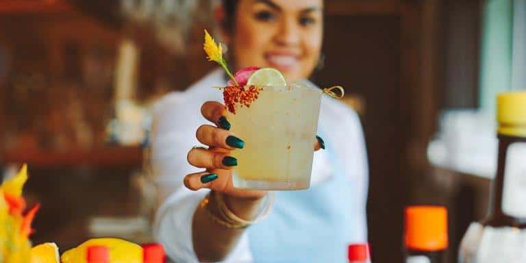 waitress holding a cocktail drink
