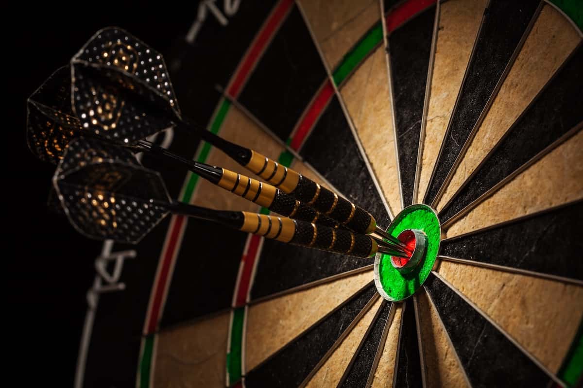dart board with 3 darts in the bullseye