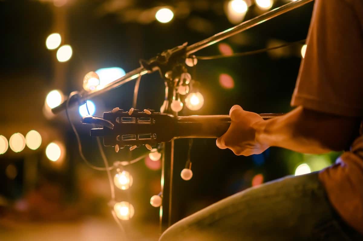 close up of a man playing a guitar in Minneapolis