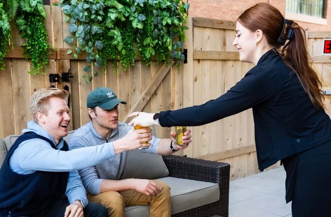 Waitress serving drinks on the patio at the Rabbit Hole