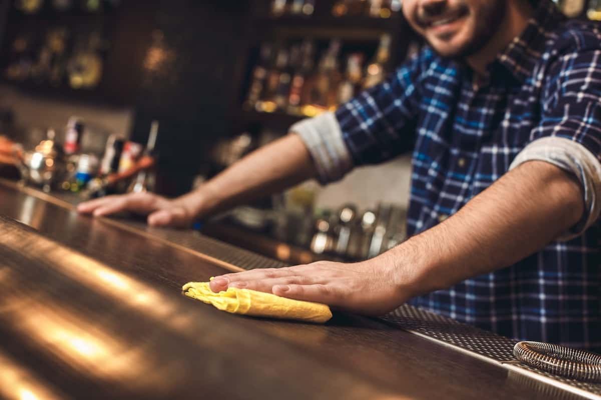 bartender cleaning countertop