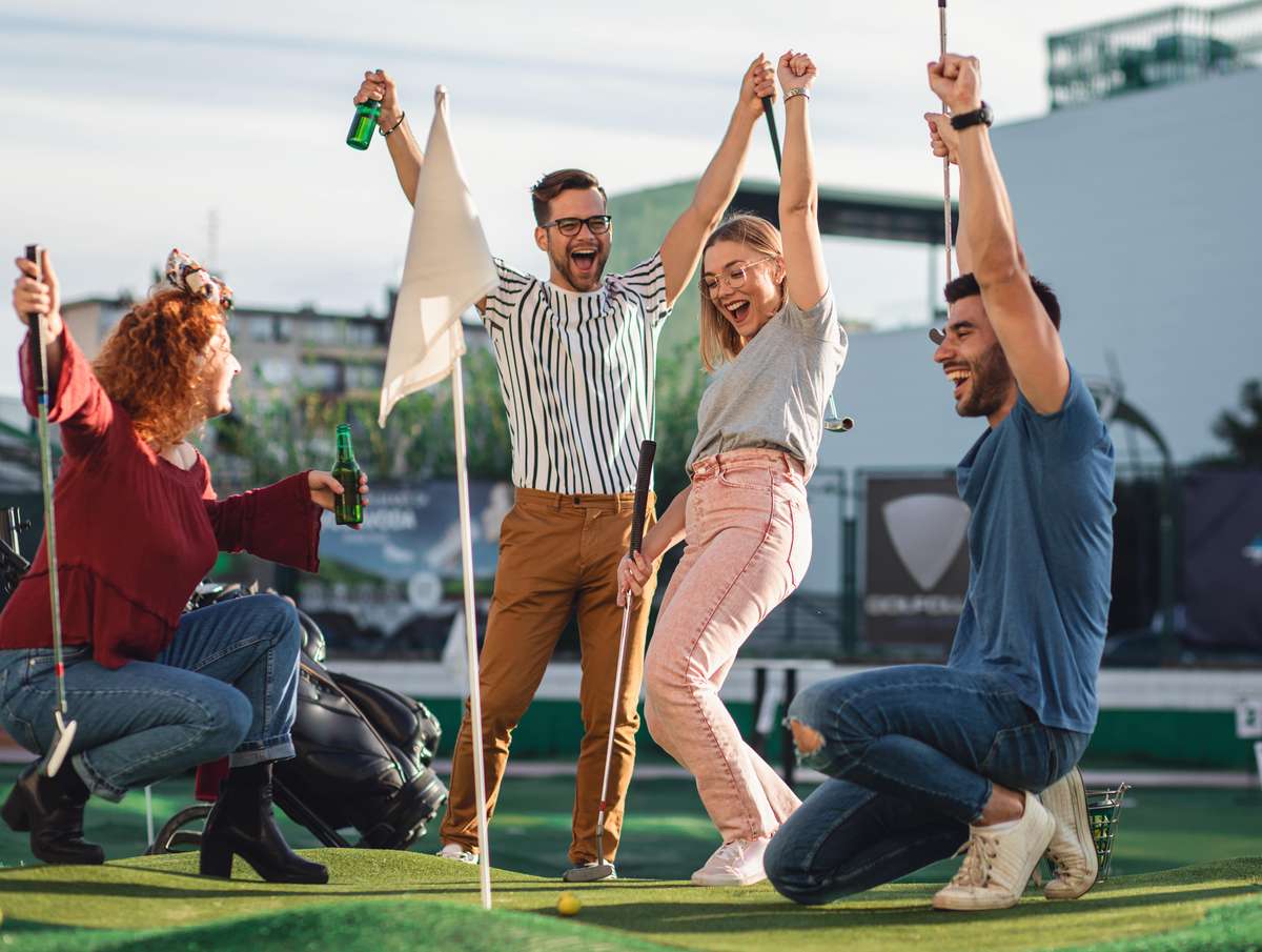 group of people playing minigolf