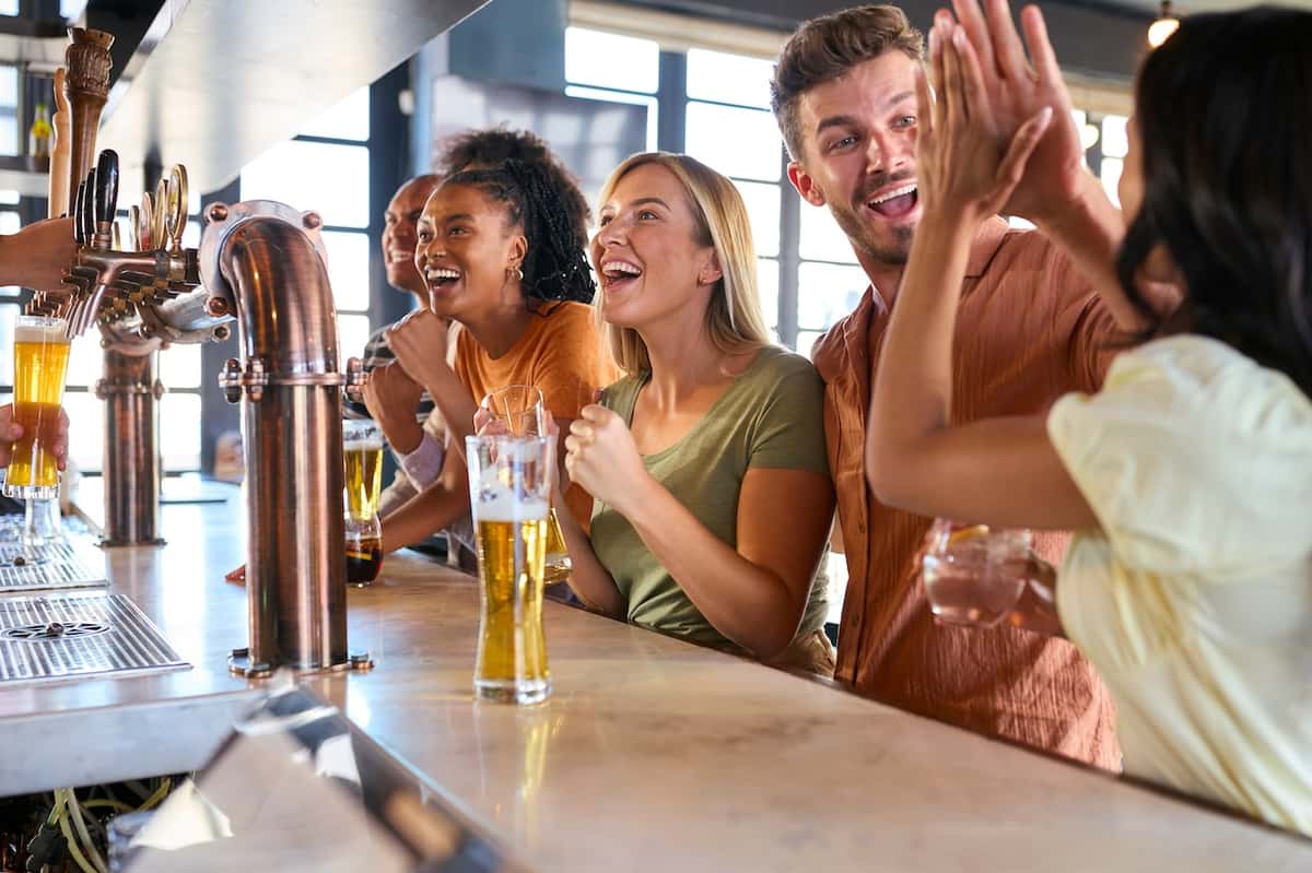 a perfect high five between two people watching sports at The Rabbit Hole