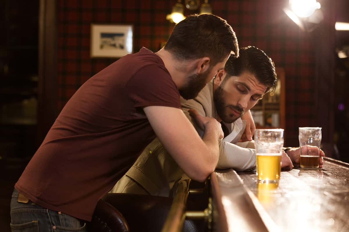 bartender assisting a drunk customer
