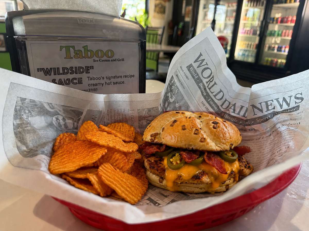 Burger served with a side wrapped in newspaper