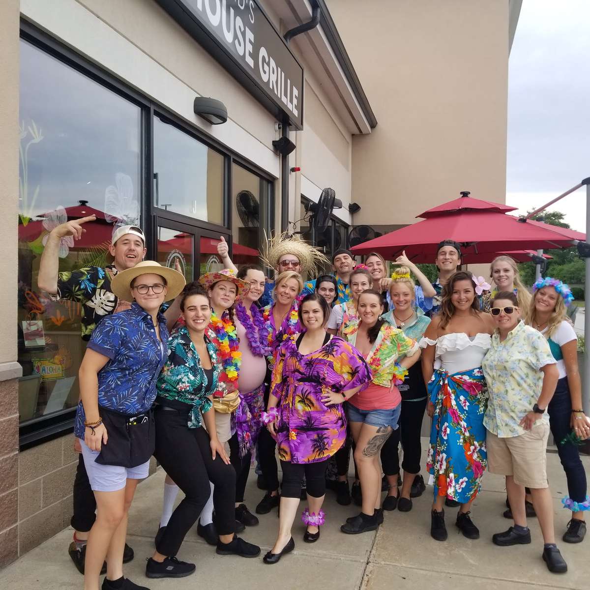 The Tap House Grille team gathered in front of the restaurant on Pig Roast Day
