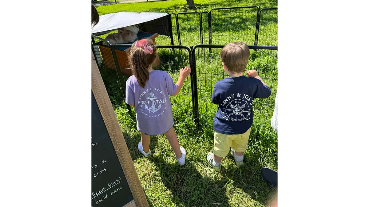 Two young kids wearing Fish Tale Shirts at Farm