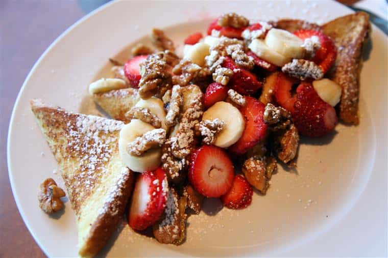 French toast with walnuts, strawberries, bananas.