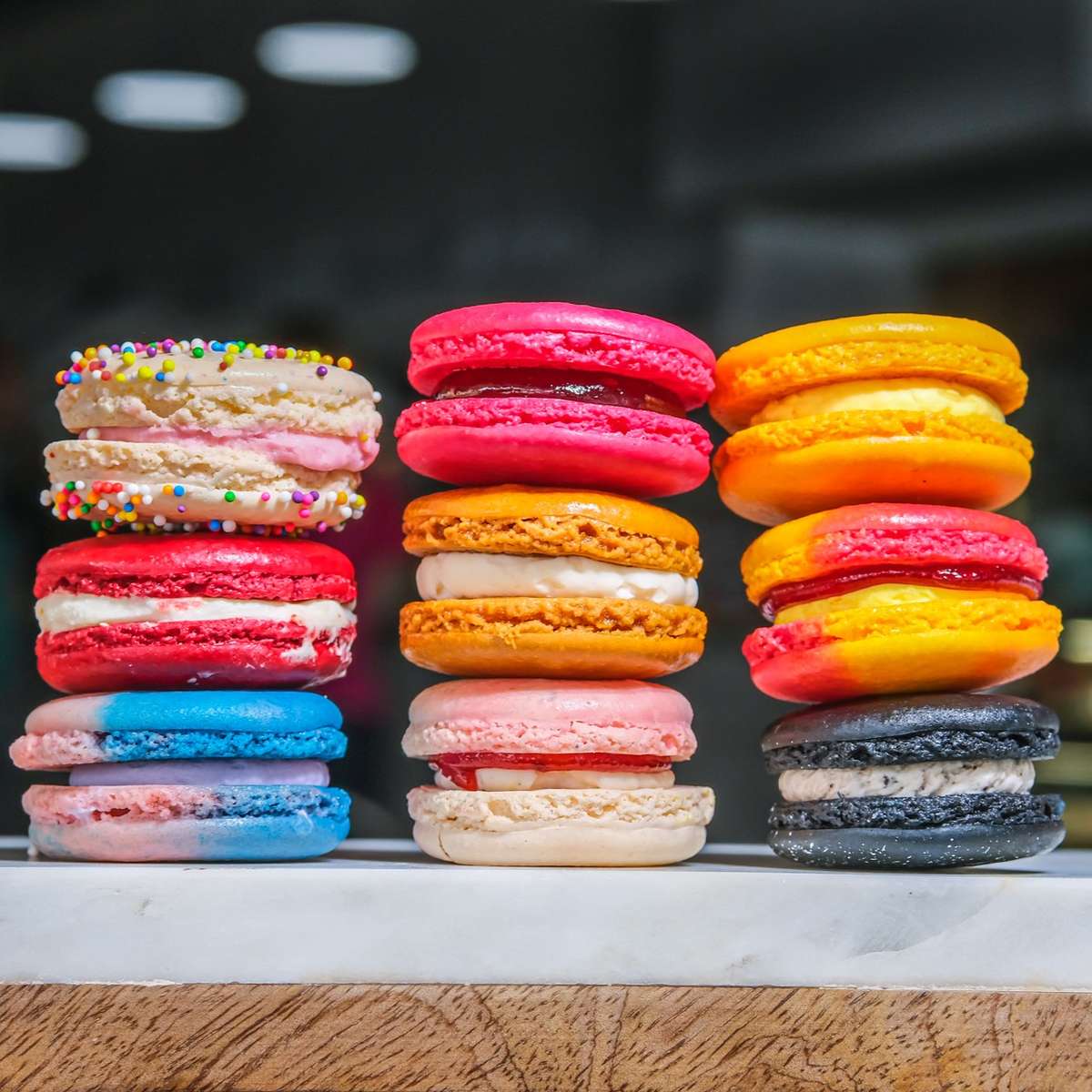 Vibrant assortment of handcrafted French macarons in a variety of flavors at Bread & Butter Bakery and Cafe.
