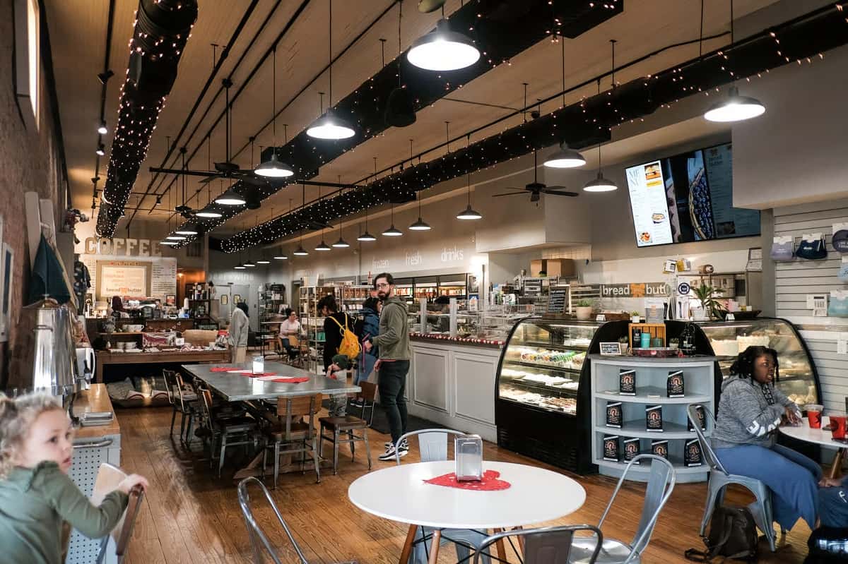 Spacious Bread & Butter Bakery + Cafe interior featuring a coffee bar, baker