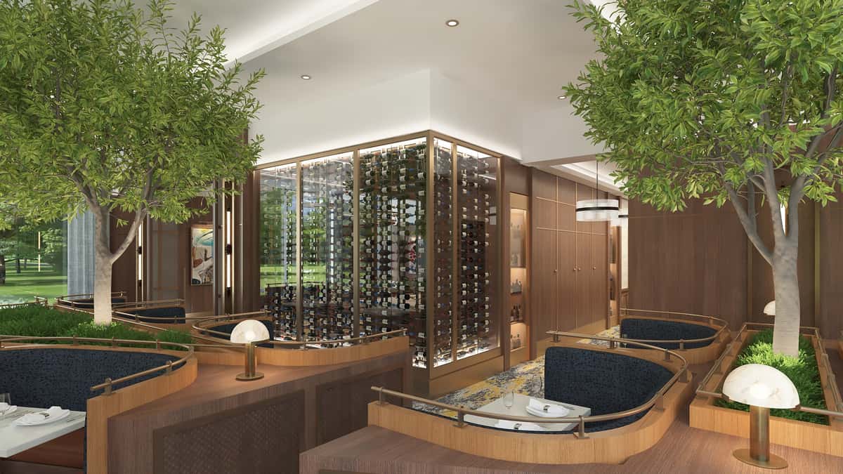 Refined dining room featuring a glass-enclosed wine display, warm wood accents, and sophisticated fine dining ambiance.
