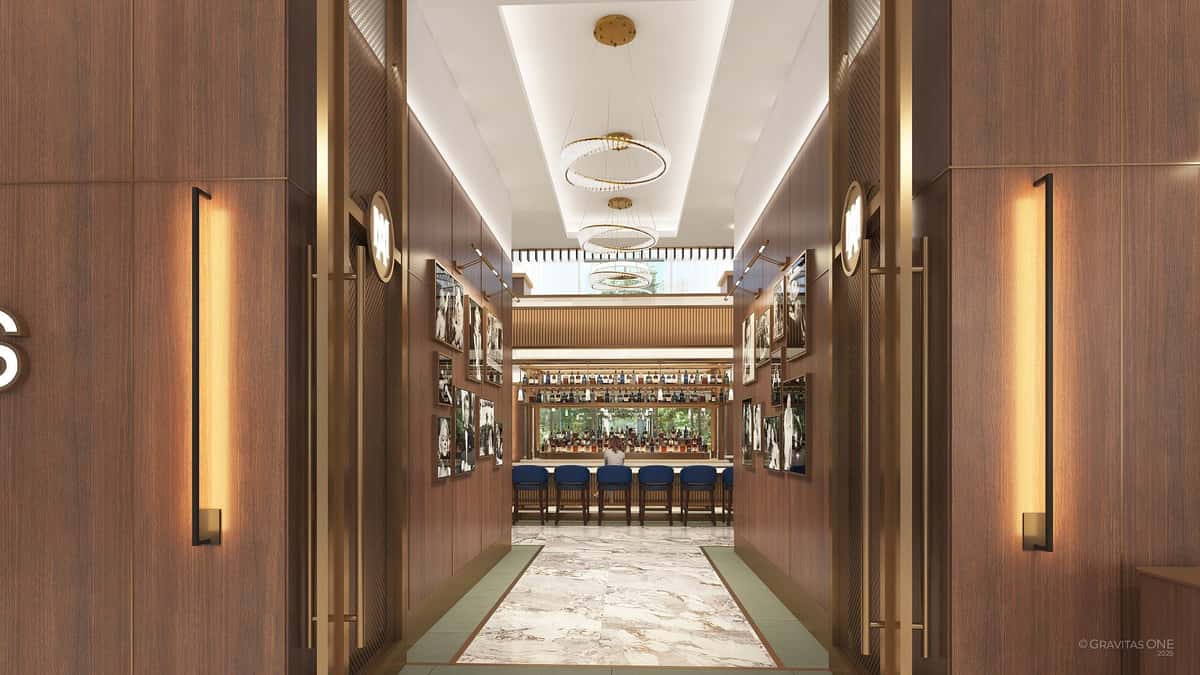 Grand restaurant entrance hallway featuring illuminated wine displays, chandeliers, and a luxurious dining atmosphere.