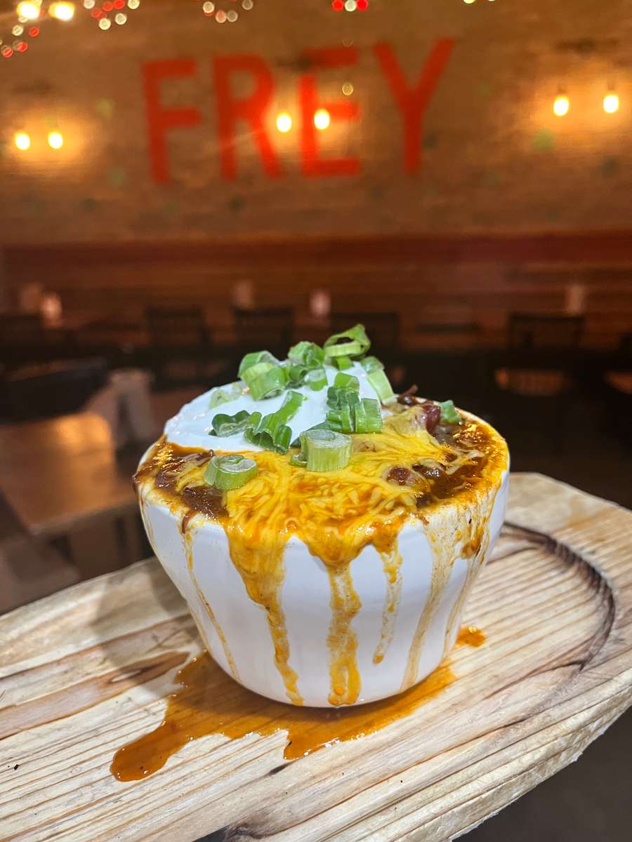 Brisket chili topped with cheddar, sour cream, and green onion.