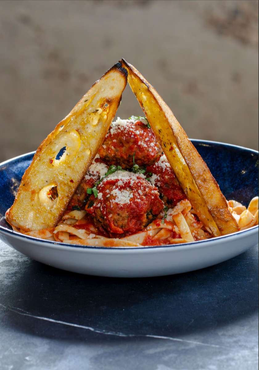 Plate of meatballs pasta and sliced bread
