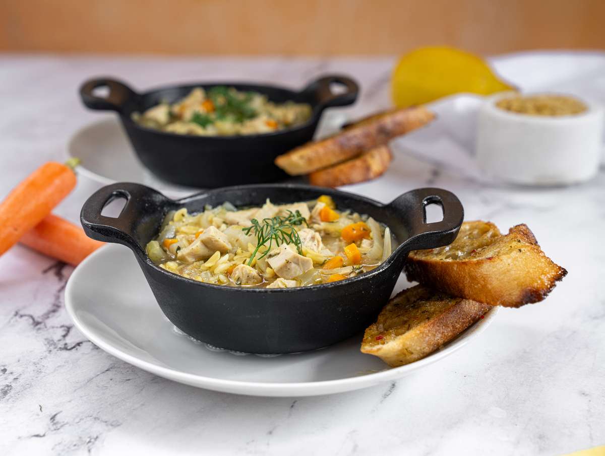 Cast iron bowl of soup with bread