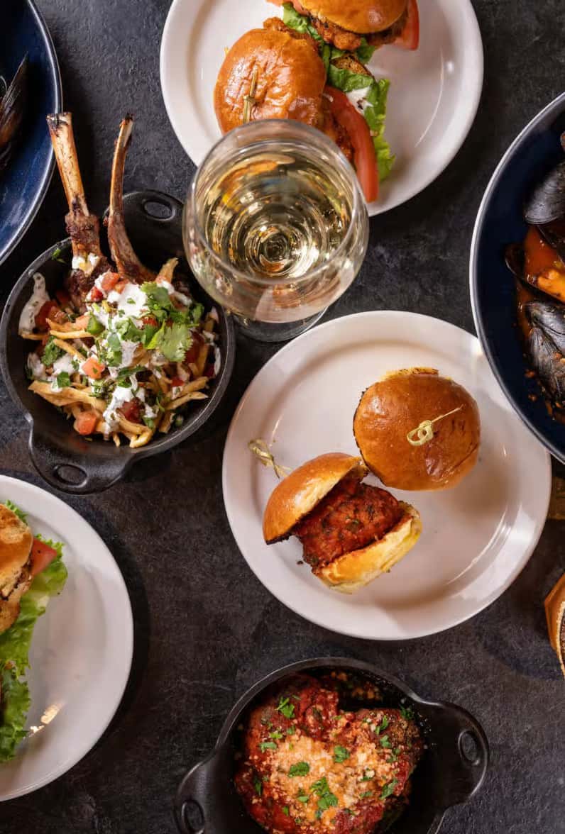 Top down view of dishes spread on dark table