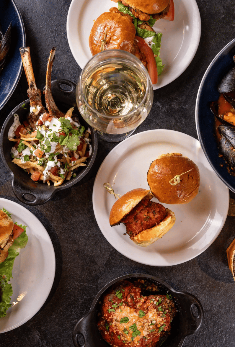 Table full of entrees and drinks from eggspectation