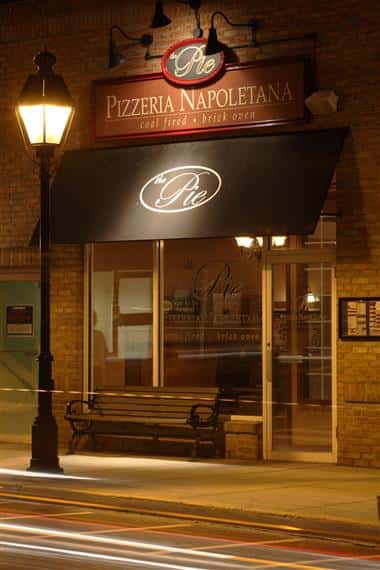 store front with sign reading The Pie Pizzeria Napoleotana coal fired brick oven