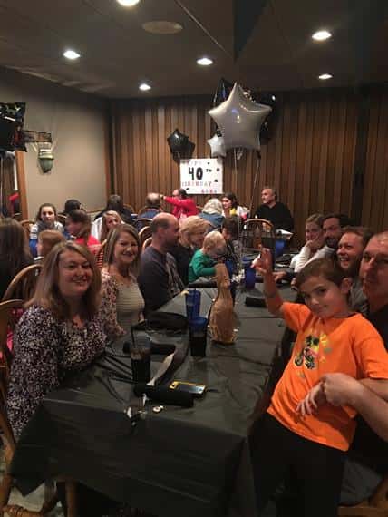 people sitting at tables posing for picture