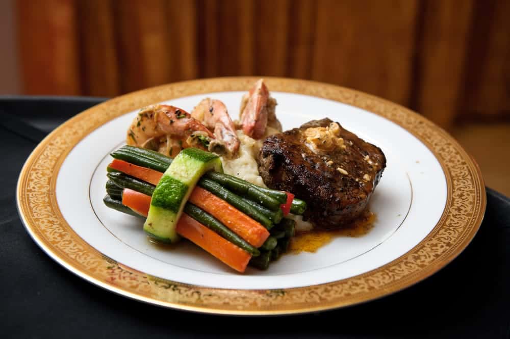 Short Rib Paired with Jumbo Shrimp Scampi, Served with Roasted Garlic Mashed Potatoes and String Beans, Peppers, Carrots in Zucchini Ring