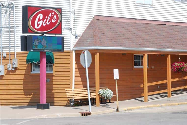 Exterior of Gil's Supper Club next to bench
