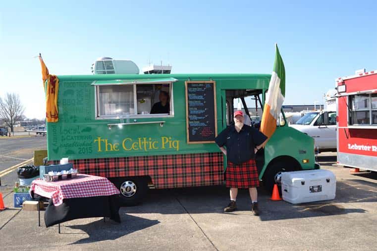 The Celtic Pig's food truck getting ready for service with the head chef standing next to it. 