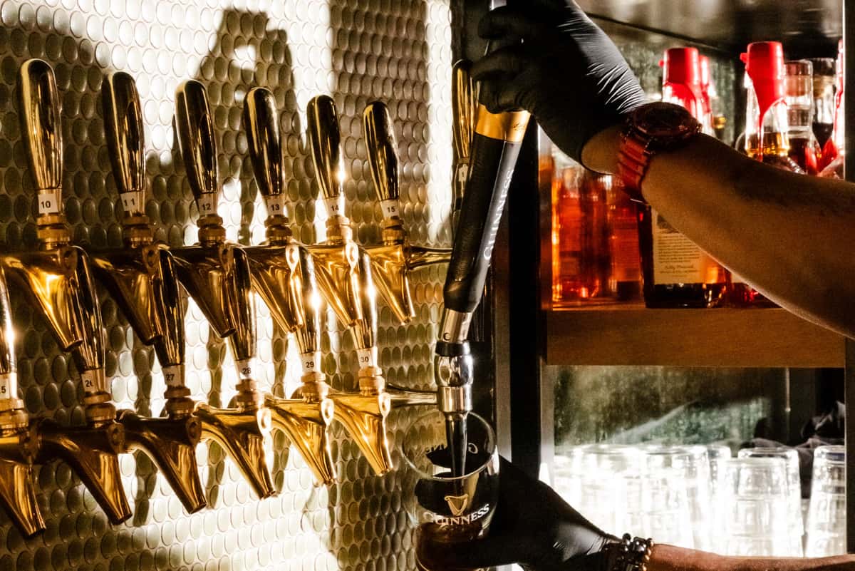 Pouring a Guinness at The Craic tap wall